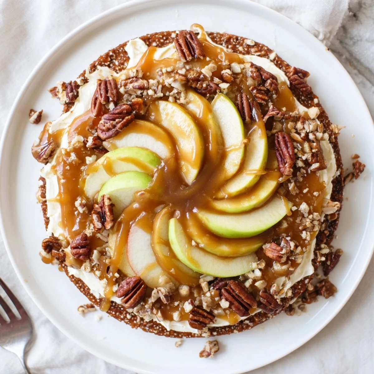 Deliciously creamy caramel apple pizza garnished with a sprinkle of flaky sea salt.