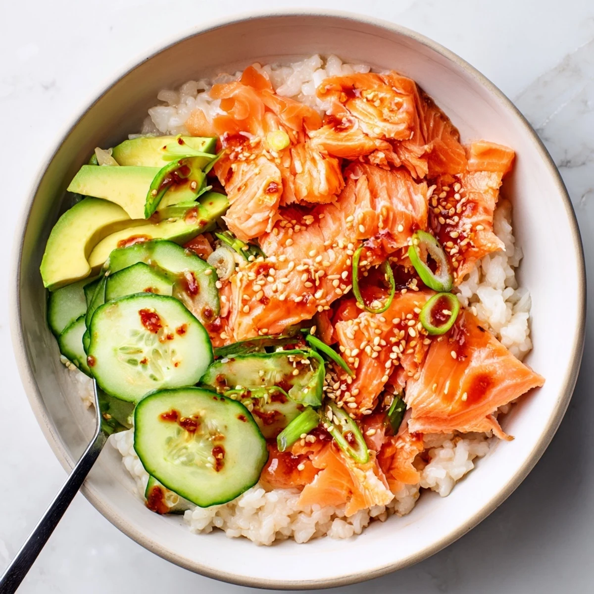 Steam-heated leftover salmon and rice bowl drizzled with soy sauce and sesame oil.