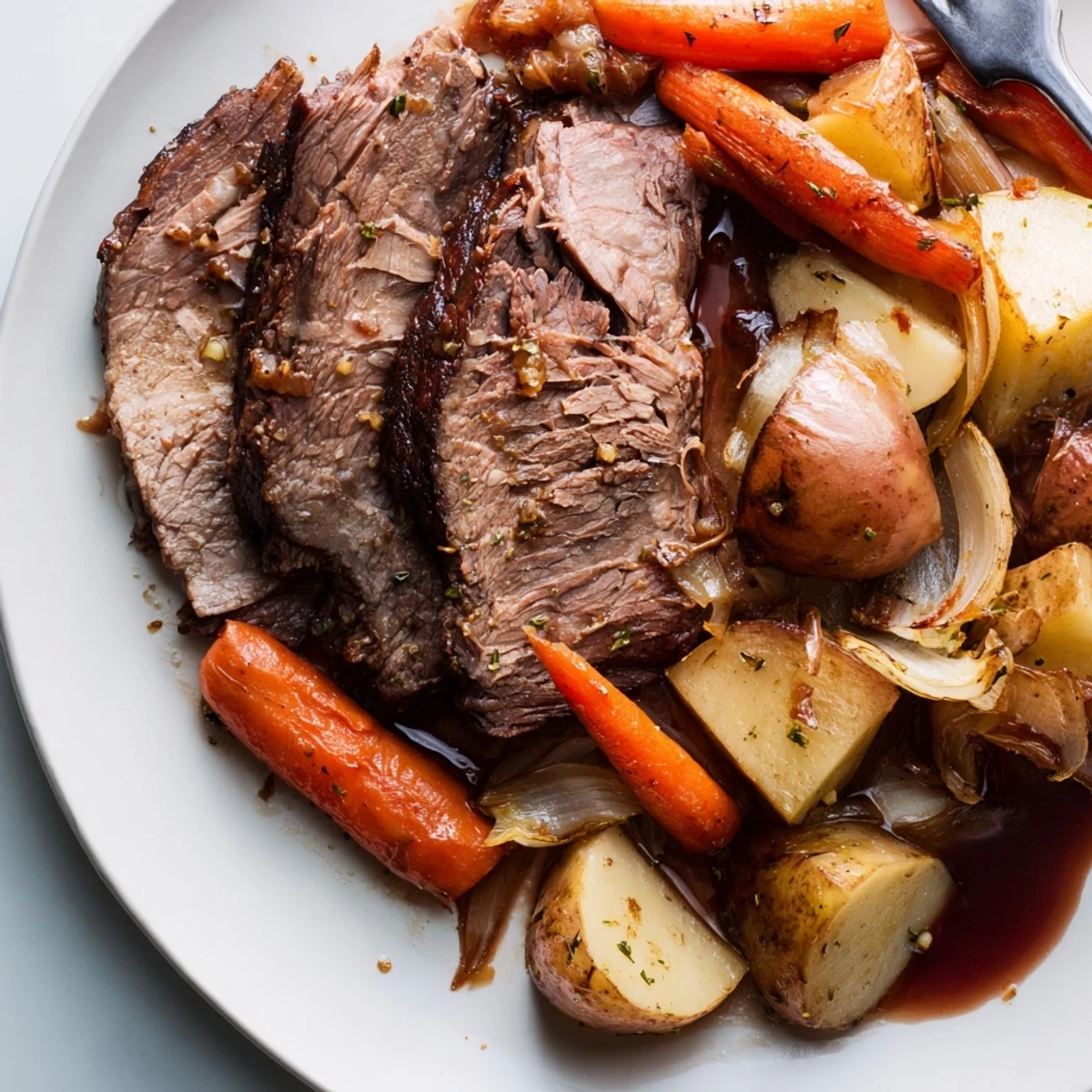 Tender Sunday pot roast served with colorful roasted veggies for a cozy meal.  