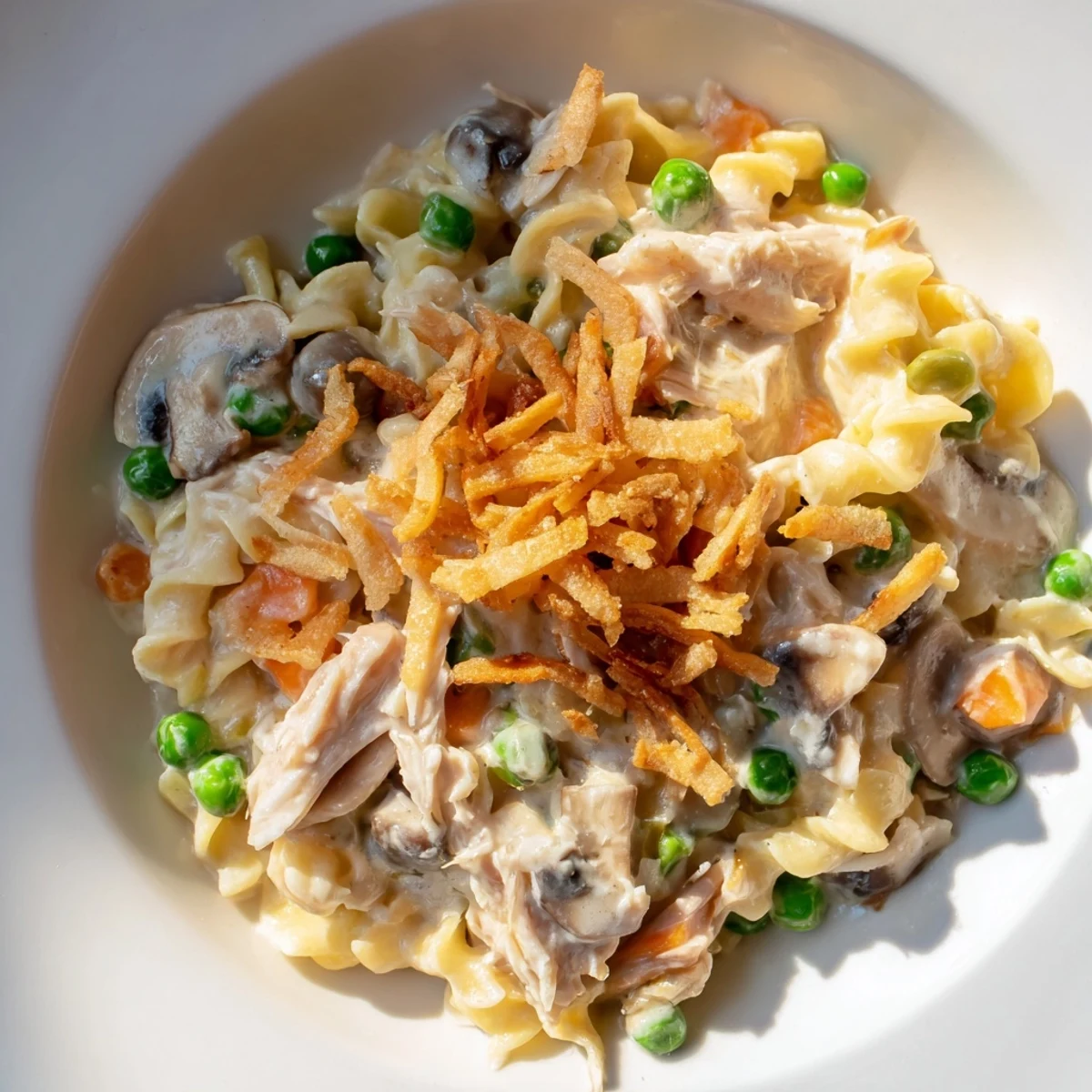 Creamy Tuna Noodle Casserole with a golden crispy onion topping, a classic comfort food meal.