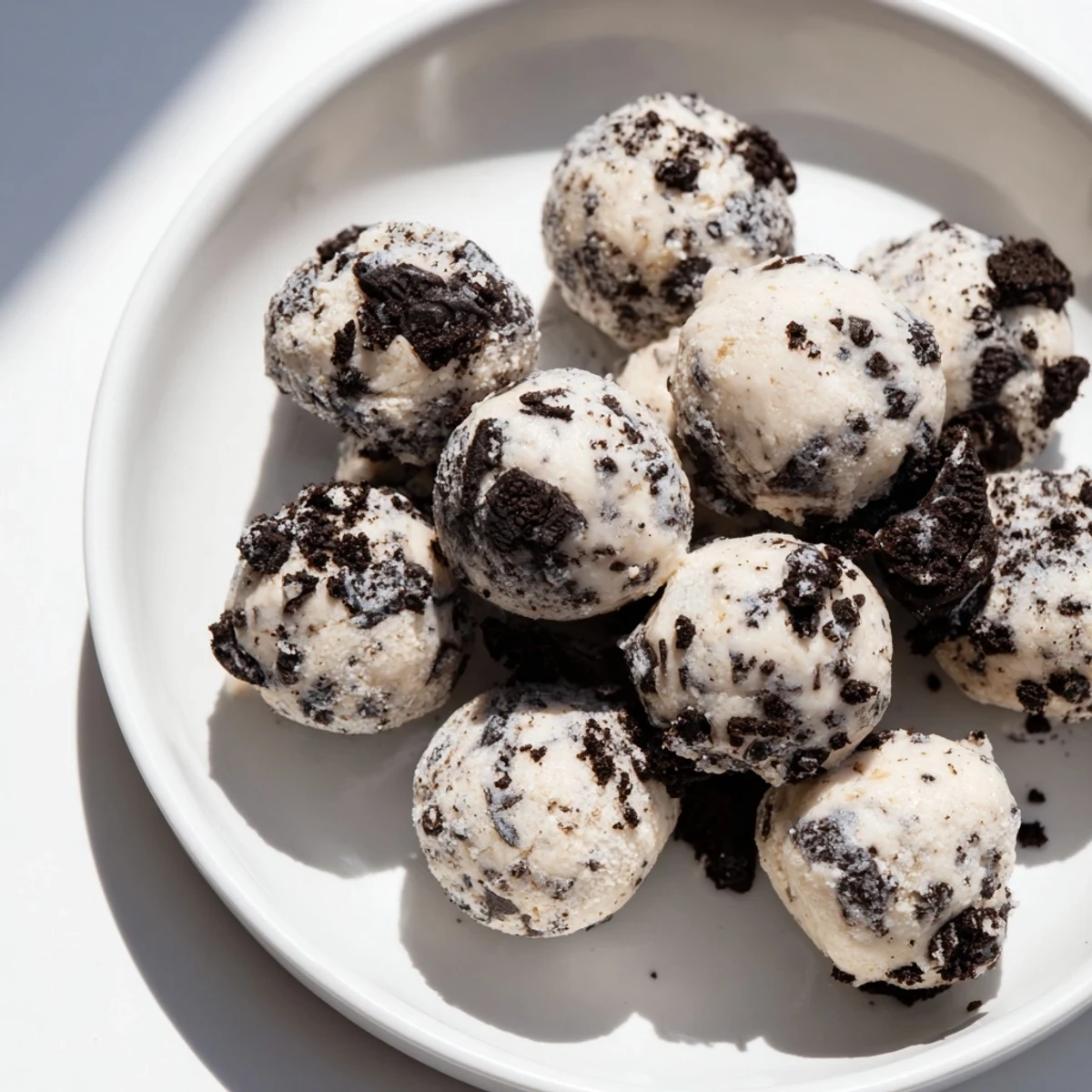 Close-up of Cream Cheese Oreo Protein Balls, showing creamy texture and crunchy Oreo bits.