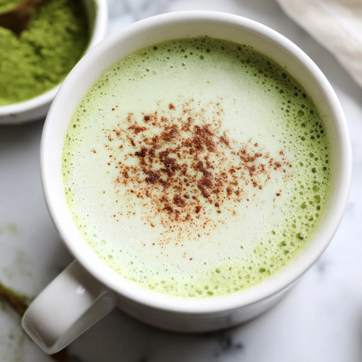 Enjoy a dairy-free Cinnamon Maple Oat Milk Matcha Latte; the perfect blend of matcha, cinnamon, and maple.