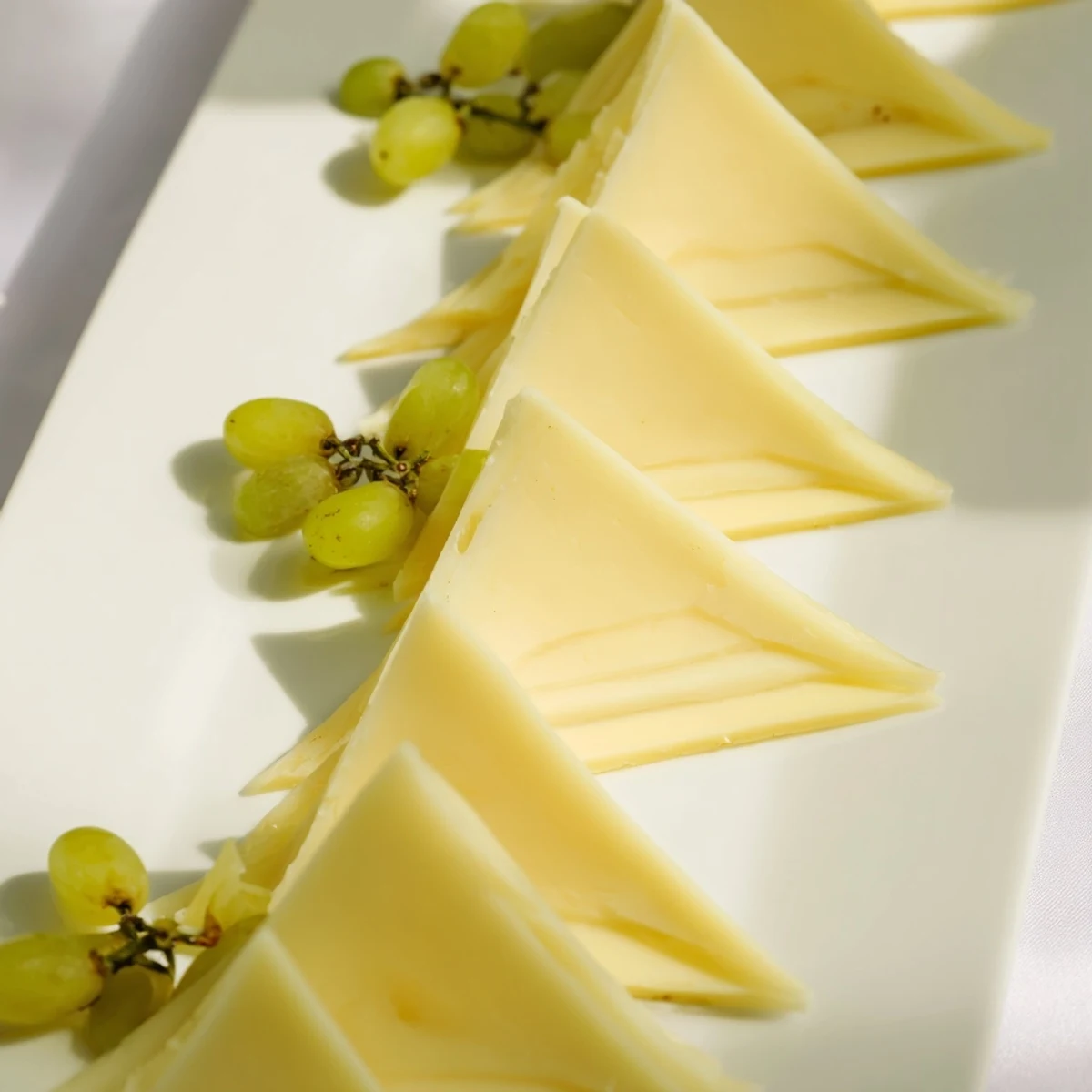 Bright, eye-catching cheese board featuring The Tannenbaum Border design, perfect for holiday appetizers, ready to serve.