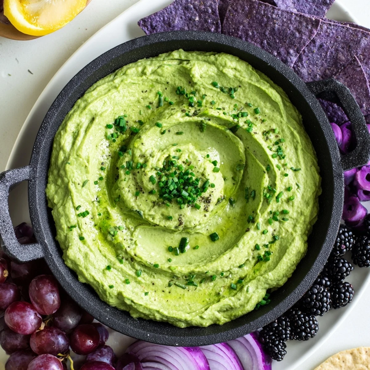 Witch's Brew cauldron appetizer: A creamy green dip in a black cauldron, surrounded by spooky, dark ingredients.