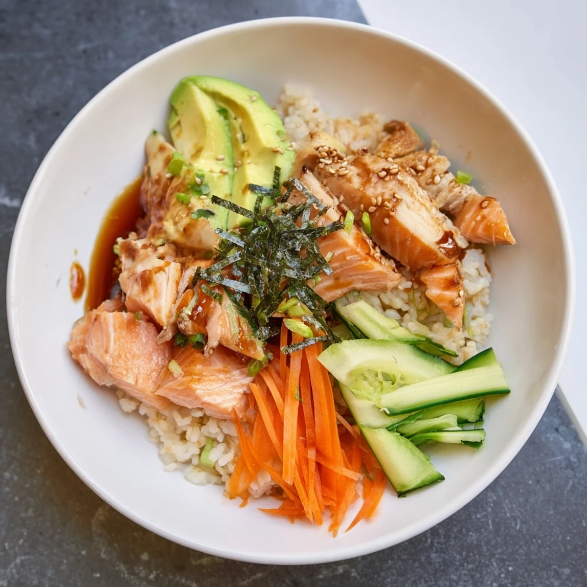 Japanese-Style Salmon & Chicken Rice Bowl: a colorful bowl with glistening salmon, chicken, and perfectly steamed rice.