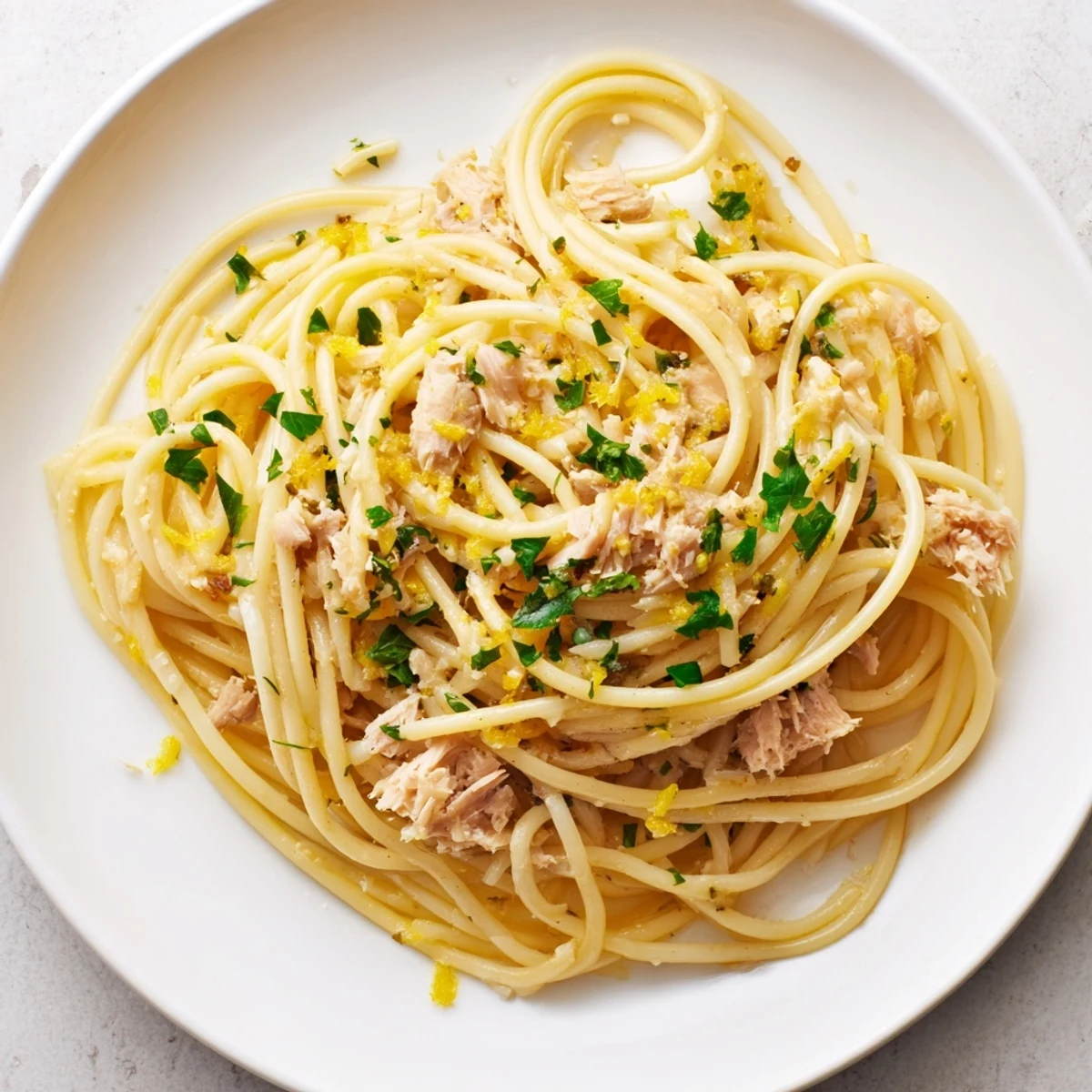 Enjoy a steaming bowl of Lemon-Garlic Tuna Spaghetti, a quick and delicious Italian meal.
