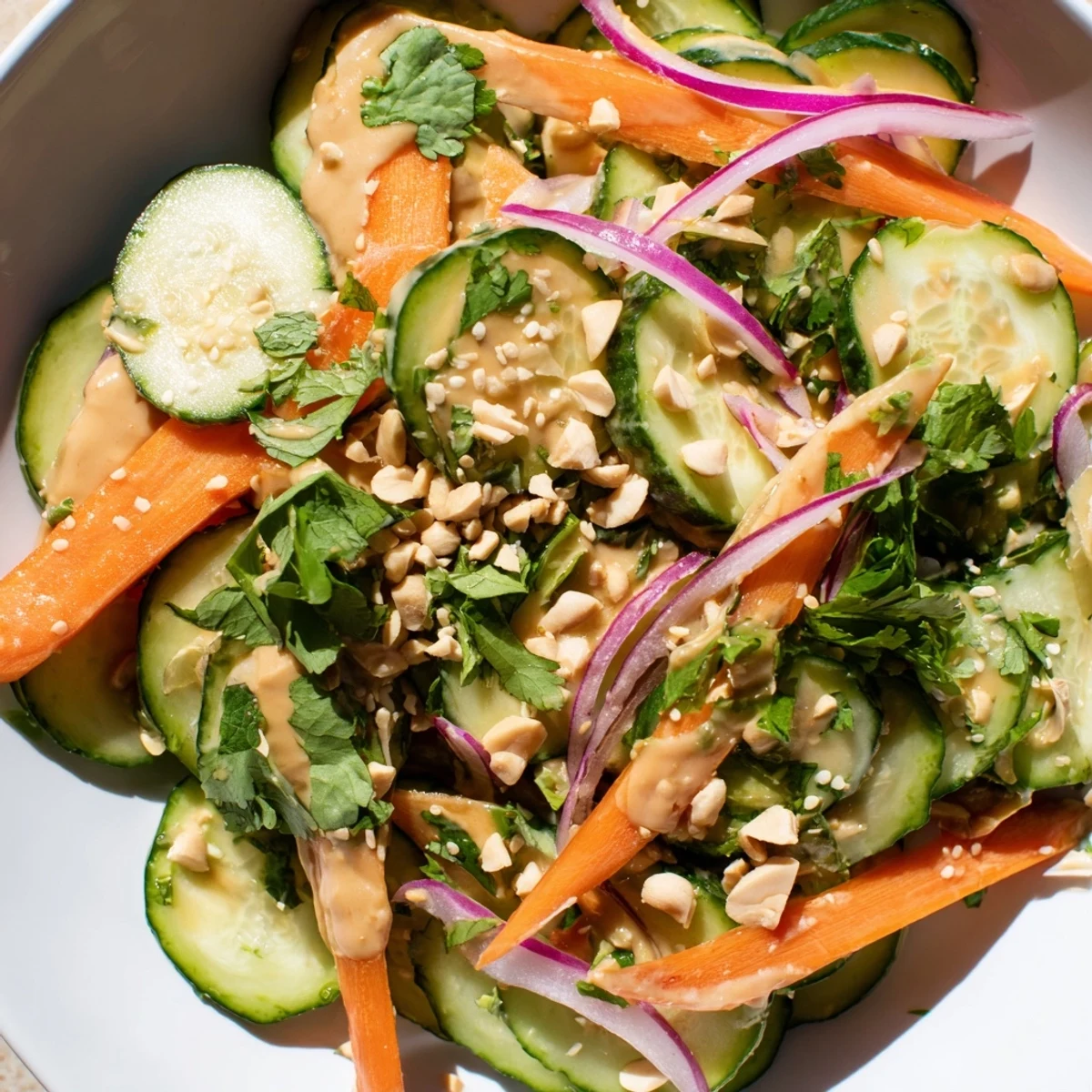 Fresh, vibrant Thai-Style Peanut Cucumber Salad, with crunchy cucumbers and a creamy peanut dressing.
