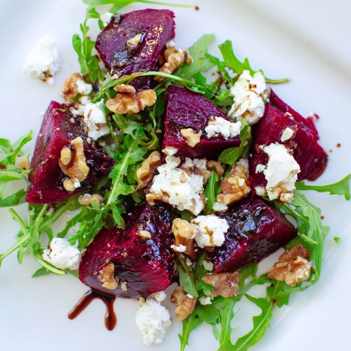 Roasted Beet Goat Cheese Salad with tender golden beets, peppery arugula, crumbled goat cheese, and crunchy toasted walnuts.