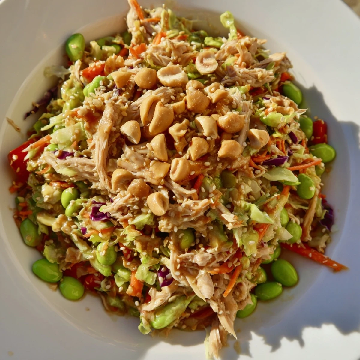 Serve this refreshing Edamame Crunch Chicken Salad as a protein-packed lunch or light dinner, drizzled with a bright ginger-lime dressing.