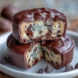 1. Rich homemade peanut butter cups filled with eggless chocolate chip cookie dough, offering a decadent blend of creamy and crunchy textures in every bite.