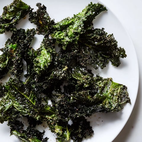 Golden, crispy baked kale chips, a healthy snack, ready for that satisfying crunch.