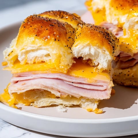 Golden-topped Budget-Friendly Ham & Cheese Sliders, hot from the oven with bubbly, melted cheese and savory ham.