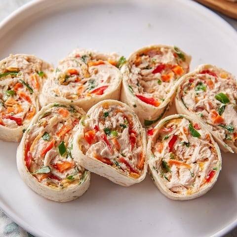 Cozy Scarf Holiday Pinwheel Wraps arranged artfully on a platter, ready to be enjoyed as a festive appetizer.