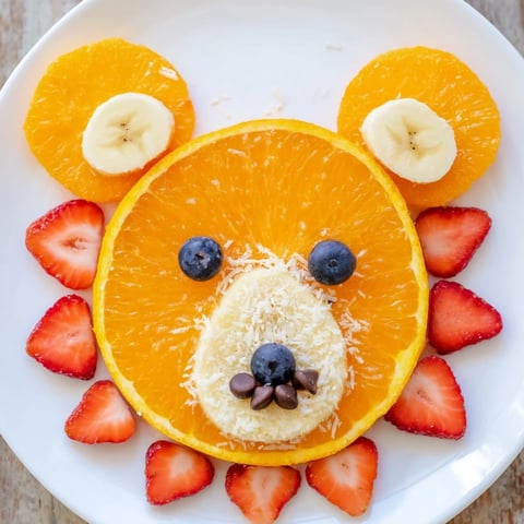 Adorable Orange Slice Bear Face fruit board, perfect for a healthy and fun kids snack or party platter.