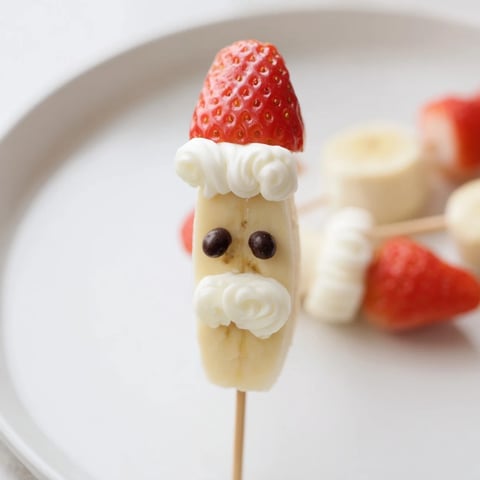 Festive Banana Strawberry Santa Skewers, a colorful holiday snack with fresh banana, ripe strawberry, and chocolate.