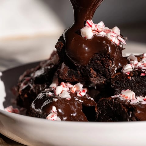 Warm, fudgy Peppermint Mocha Brownie Bites topped with a glossy chocolate glaze, ready to enjoy.