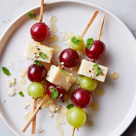 Sparkling Grape and Cheese Skewers with vibrant red grapes and golden cheese for a delicious appetizer.