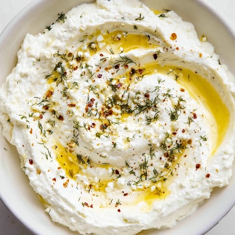 Creamy Angel Wings Whipped Feta Dip, drizzled with honey and fresh herbs, perfect for dipping.