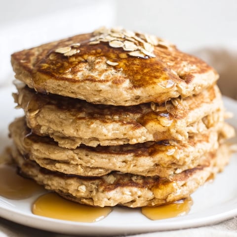 Golden-brown banana oat pancakes stacked high, offering a delicious, healthy U.S. breakfast option.