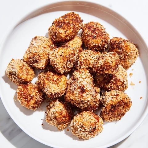 Golden, crispy Spicy Yogurt Chicken Bites, ready to be dipped and enjoyed as a snack.