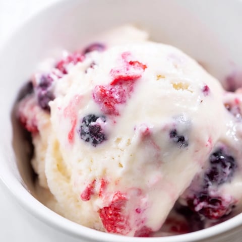 A close-up of creamy cottage cheese ice cream, swirled with purple berries, perfect for dessert.