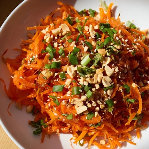 Vibrant Spicy Carrot Salad with shredded carrots, a bright orange, ready to be enjoyed.