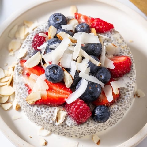 Creamy Berry Chia Pudding layered with vibrant berries, a delightful vegan breakfast ready to enjoy cold.
