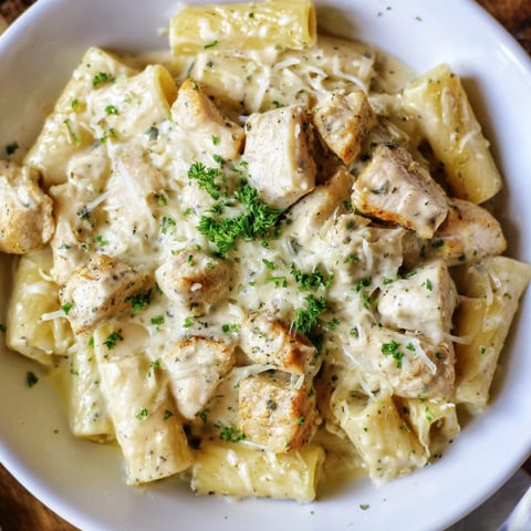 Golden-brown Chicken Alfredo Bake bubbling with melted cheese, promising a rich, creamy, satisfying dinner.