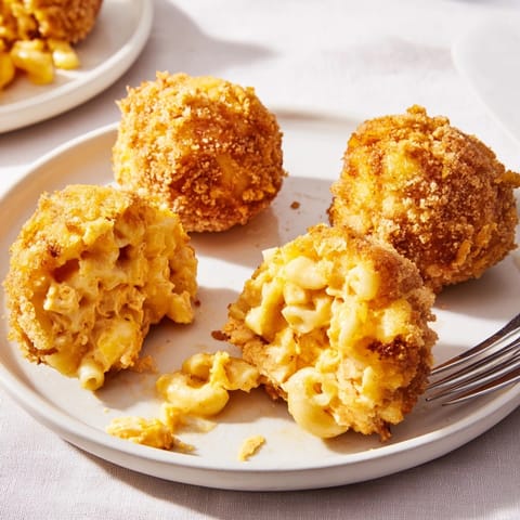 Close-up of cheesy Mac and Cheese Buffalo Chicken Balls with a fiery buffalo kick.