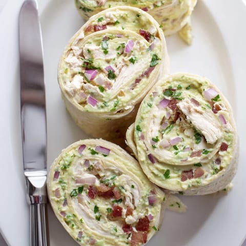 Golden, savory bites: Chilled Avocado Chicken Bacon Pinwheels recipe sliced, ready to serve.