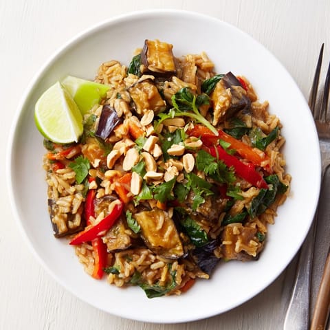 A savory, steaming Thai Peanut Eggplant Rice Bake ready for serving–fragrant peanut sauce.
