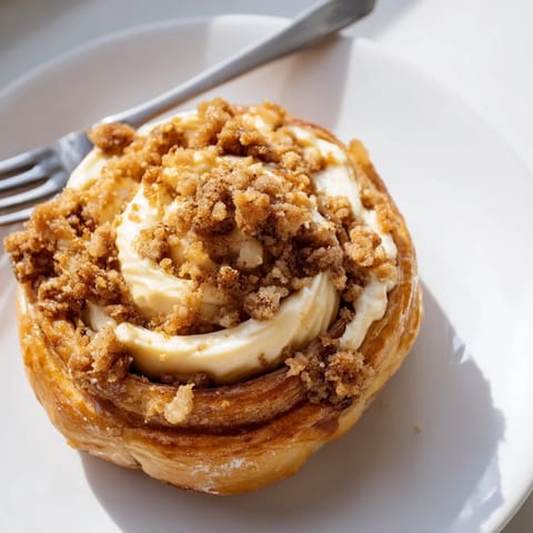 Rich coffee cream cheese filling peeks through a golden brown crust on this Danish treat.  