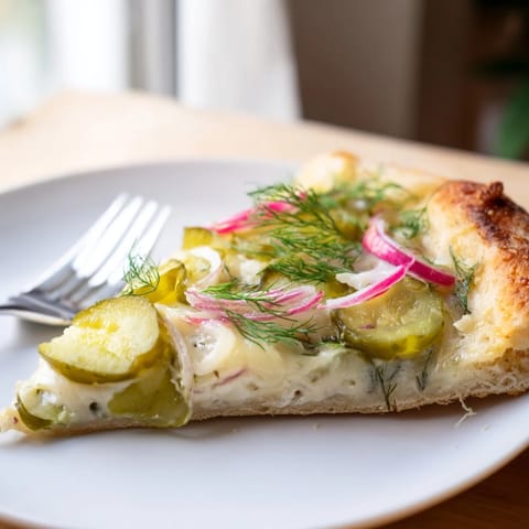 Creamy crème fraîche and crunchy dill pickles on a hot, cheesy pizza.  