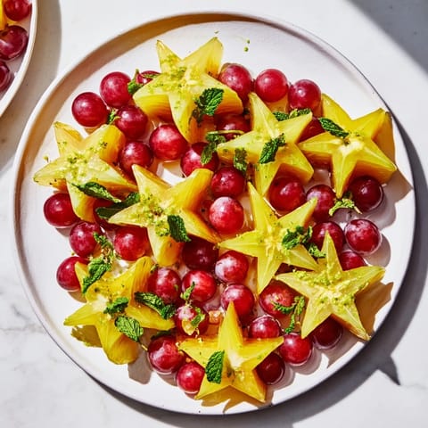 Freshly arranged sliced starfruit and juicy grapes making a colorful, healthy fruit plate for brunch.