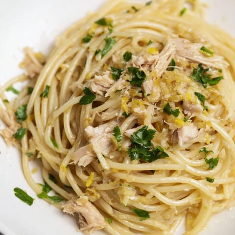 Close-up of golden spaghetti with lemon and tuna; perfect Lemon-Garlic Tuna Spaghetti.