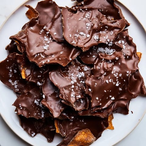 Salty potato chips are blanketed with dark chocolate, creating delicious Chocolate Potato Chip Bark.