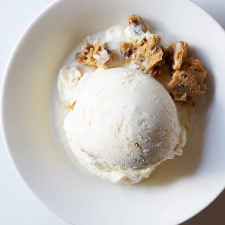 Delicious Cottage Cheese Ice Cream topped with decadent chocolate chip cookie dough chunks.