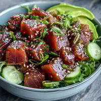 Spring Tuna Poke Bowl with ponzu-marinated tuna, crisp cucumber, radish, and creamy avocado on seasoned sushi rice.